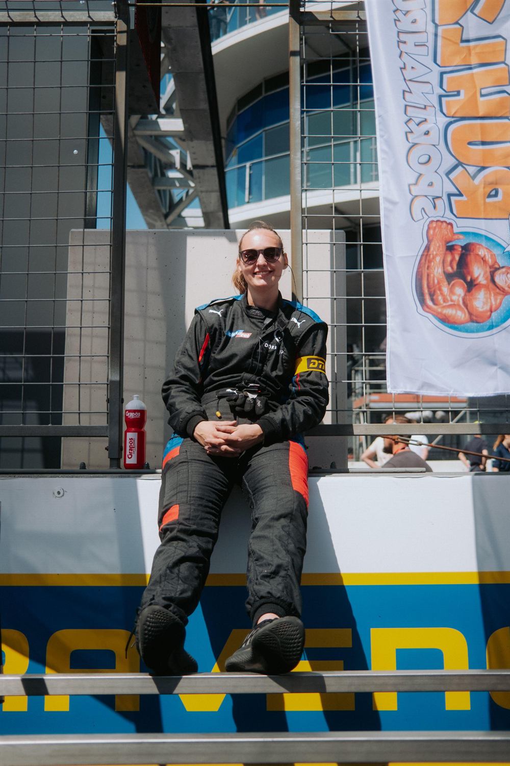 Mandy Paschen in racing gear on the pit wall